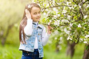 Beautiful girl in flowering Apple trees. Long hair photo
