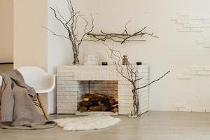 White fireplace in light room with Christmas decoration photo