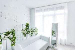 White carpet in front of settee in apartment interior with painting and lamp. Real photo