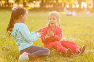 two little girls walking in the field. photo