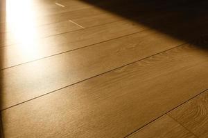 Light and shadow on laminate floor from window. Sunlight. Abstract background. Top view. photo