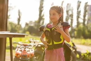 Little girl riding ATV quad bike in race track photo