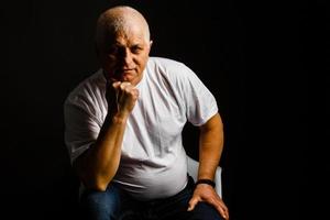 Old senior man closeup serious expression portrait photo