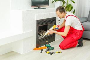 Fireplace installing in white brick wall photo