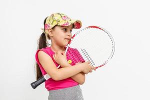 Cute little girl with tennis racket on white background. photo