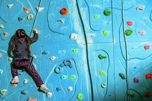 Little girl on climbing in entertainment center. photo