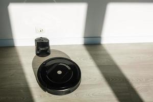 Robotic vacuum cleaner cleaning the room photo