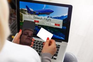 flight search on internet website, travel planning concept, airplane tickets online photo