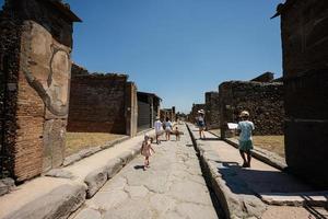 Family tourist walking at Pompeii ancient city, Italy. photo