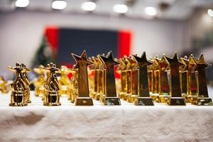 Award and victory concept. Row of golden cups of dance competition. photo