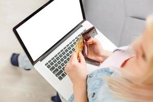 Top view of young woman sitting on floor with laptop photo