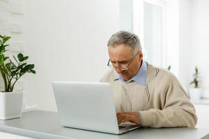 Senior man shopping on internet photo