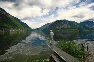Back of boy stand near lake at Hallstatt, Austria. photo