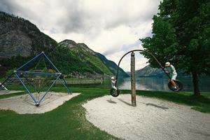 Two brothers ride on a swing from car tires at Hallstatt, Austria. photo