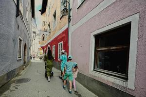 Mother with baby carriage and children walking in Hallstatt, Austria. photo