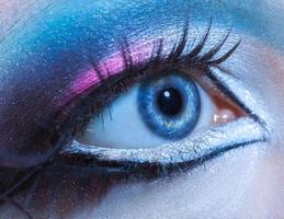 Macro picture of blue woman eye with multicolor make up. Looking away photo