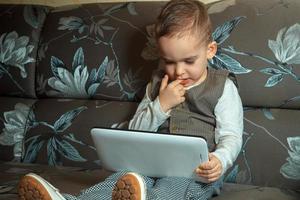 young boy with finger in his mouth photo