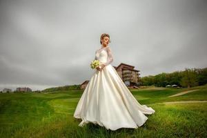 young gorgeous bride in wedding dress photo