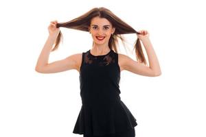 Happy young girl in black dress looking and smiling on camera isolated  white background in studio photo