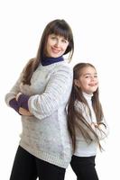 vertical portrait of cheerful mother with her daughter smiling photo