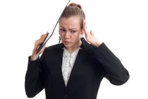 young beautiful business woman in chrenom suit keeps the hands behind the head and wrinkled her face close-up photo