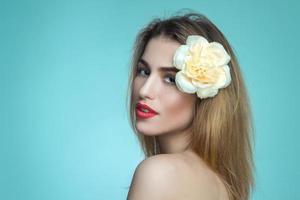Portrait of pretty girl with flower in hair photo