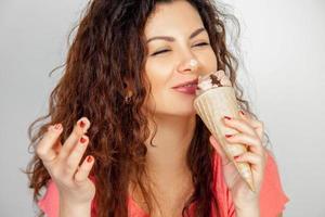 brunette girl eats chocolate ice cream photo