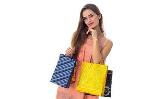 young girl holding blue and yellow bags isolated on white background photo