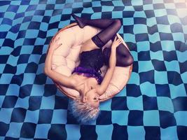 hot blonde lying on the checkered pool photo