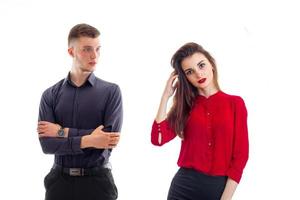 charming serious guy worth hands clasped near the beautiful girl with red lipstick and red blouse photo
