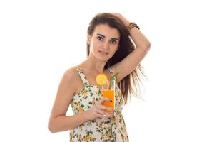 young girl holding in one hand and with the other hand orange juice keeps hair photo