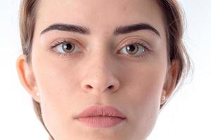 Portrait of serious young girl without makeup close-up photo