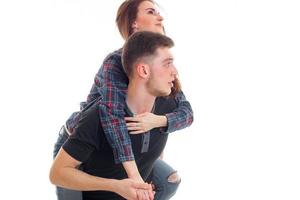 young girl climbed up on his back to the guy and a close-up of a smiling photo