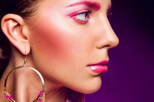 Half face portrait of female with pink make up photo