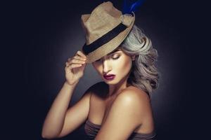 mujer encantadora con color de cabello gris y hermoso maquillaje con sombrero elegante foto