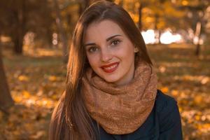 Portrait of a beautiful girl with red lips and warm scarf on the neck, close-up photo