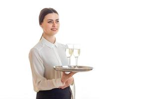 Cheerful waitress in uniform with trey in hands smiling photo