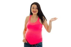 young smiling pregnant woman in a bright t-shirt raised hand photo