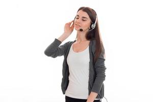 portrait of young charming call center woman woman with headphones and microphone and closed eyes isolated on white background photo