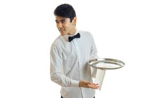 handsome young waiter's shirt smiling looks to the side and holding a tray photo