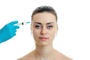 a close-up portrait smiling female doctor that does prick on her face photo