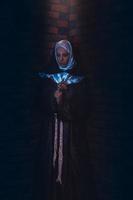 beautiful nun stand in shaft of lights photo