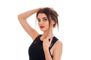 sexual young brunette lady with red lips and black dress seductive looks on the camera isolated on white background photo