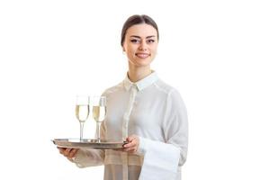 Cheerful young waitress smiling with trey in hands photo