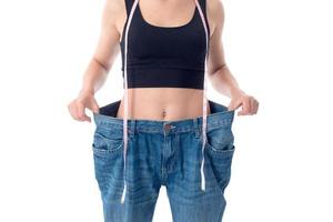 slender girl stands in huge denim pants close-up photo