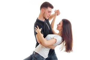 a young man holds girlfriend and tips it in dance close-up photo