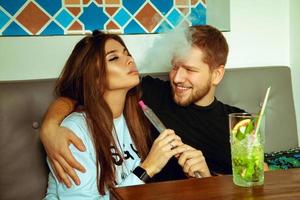 couple relaxing at the shisha bar photo