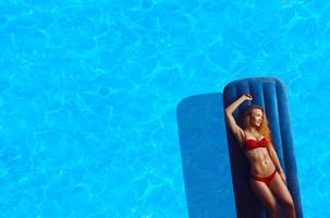 young sexual woman in red bikini photo