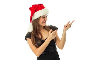 portrait of cheerful adorable girl in santa hat photo