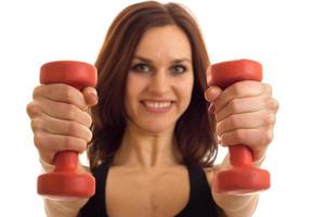 Portrait of beautiful sports girls that stretched forward dumbbells in hands close-up photo